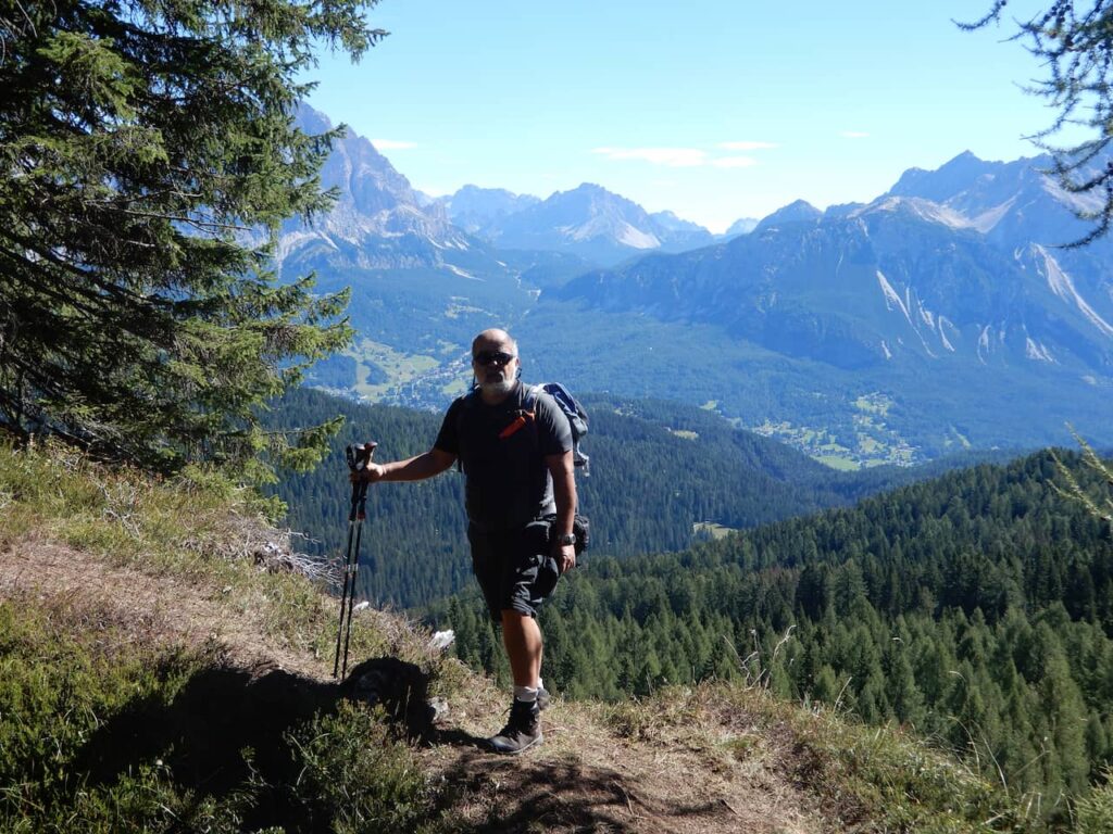 Me on the trail to Cinque Torri with views of the mountains.