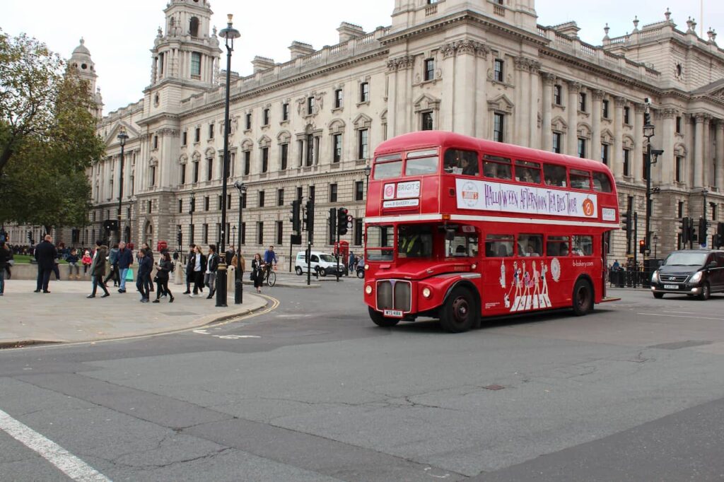 Red bus traveling in London